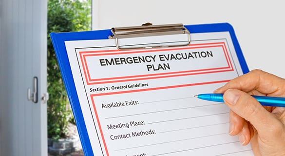 Clipboard with Emergency Evacuation Plan beside Exit Door